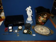 A black metal box with key, a hand painted wastepaper bin, candle snuffer, travel clocks,
