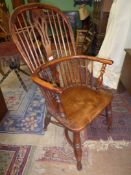 A most appealing solid Elm seated Yew and other woods bow back Elbow Chair having a fretworked