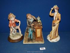 Three Capo-di-monte figures to include boy with football on wooden base, the Watchmaker,
