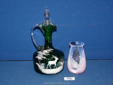 A Mary Gregory hand blown green glass decanter, hand painted with a woodland scene of a deer,