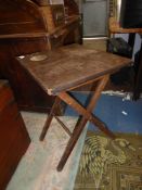 An old folding action Satinwood occasional Table of coaching table type,