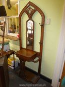 A medium Oak Hallstand/umbrella Stand of Gothic arch shape having a fretworked panel,
