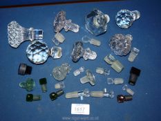 A quantity of glass decanter stoppers and various perfume stoppers.