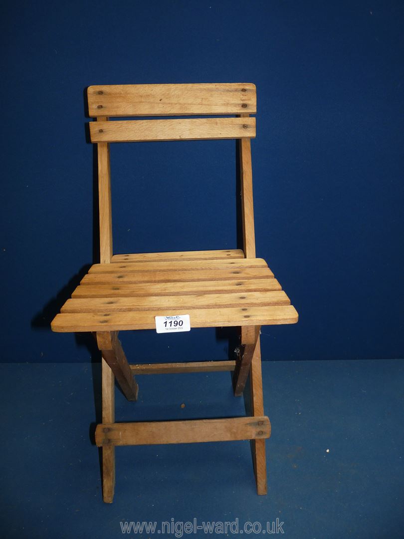 A very appealing child's folding Chair in Beechwood, 21 1/2'' high x 11'' wide.