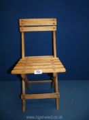 A very appealing child's folding Chair in Beechwood, 21 1/2'' high x 11'' wide.