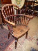 A charming solid Elm seated child's bow backed open armed stickback Chair having turned legs,