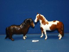 Two Beswick horses: Bay Shetland pony and a Skew bald Pinto pony both 6" tall approximately.