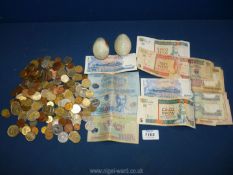 A box of foreign currency including coins and notes, plus two Onyx eggs.