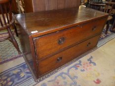 A surprisingly heavy low dark Mahogany Chest of two long drawers having turned recess knobs,