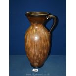 A large brown pottery Jug with detailed handle, 15" tall.