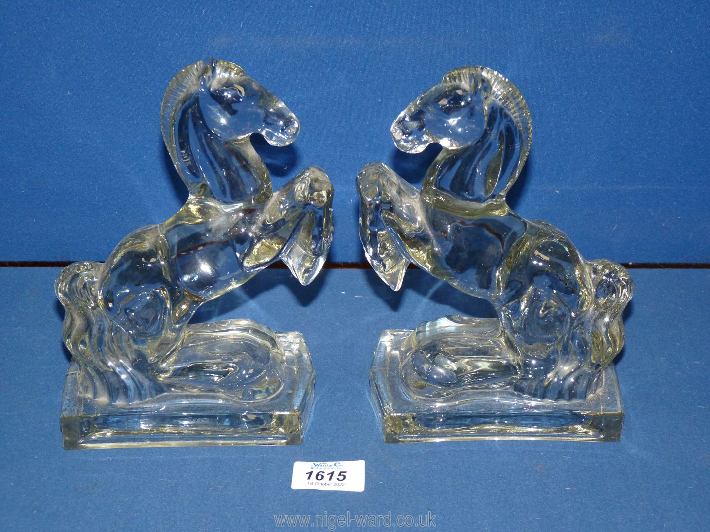 Two glass bookends in the form of rearing horses, 8 1/2" tall.