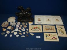 A small quantity of mixed shells and a small piece of coral, four hand embroidered greeting cards,