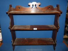 A dark Mahogany table top or wall hanging Shelf unit with fretworked detail,