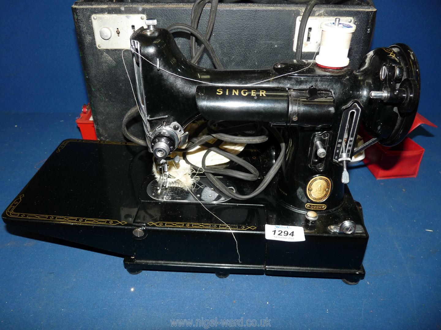 A cased Singer Featherweight 222K compact electric Sewing Machine,