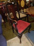 A dark Mahogany open armed elbow Chair having crook like arm supports,