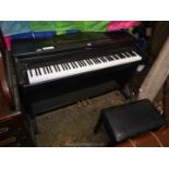 A dark Rosewood finished Roland HP237e Digital Piano having a 6 1/2 octave keyboard and complete