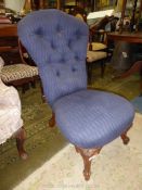 A Victorian buttonback low/nursing Chair upholstered in navy blue lattice patterned fabric and