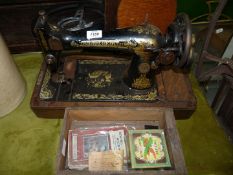 A Singer hand Sewing Machine and accessories, serial no. F4485677.