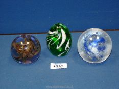 Three glass paperweights including St John's crystal in splash design,