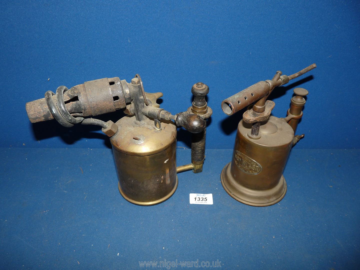 Two old Brass Blow lamps, one having a card-wrapped handle, the other "Hot Blast-Whie Mfg Co,