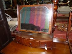 A Georgian Mahogany swing Mirror having a bow fronted base with three trinket drawers,