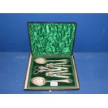A presentation cased set of berry spoons, grape scissors, nut crackers, and picks.