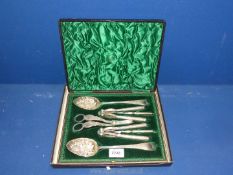 A presentation cased set of berry spoons, grape scissors, nut crackers, and picks.