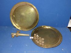 Two brass trays, brass wine barrel tap, and some brass weights.