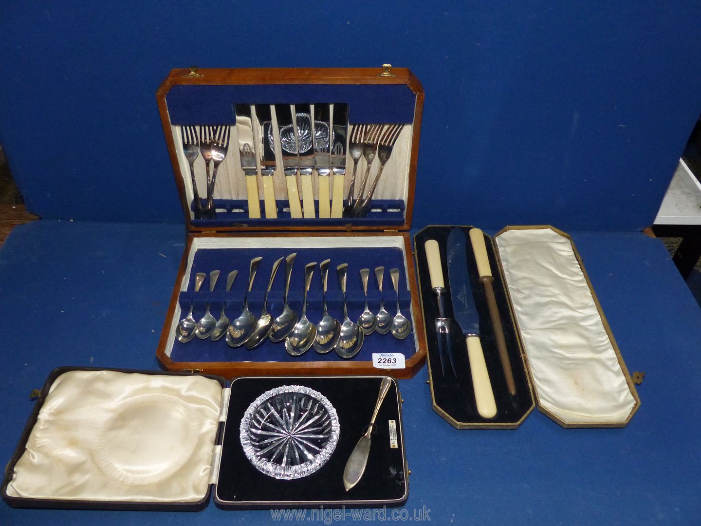 A quantity of cutlery, knives, boxed cut glass butter dish, and boxed knife carving set.
