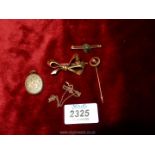 Two 9ct gold brooches, one bow shaped, a gold locket and a red stone hat pin.