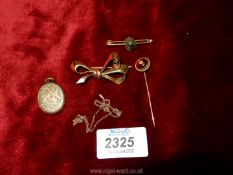 Two 9ct gold brooches, one bow shaped, a gold locket and a red stone hat pin.