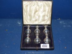 A cased set of six Silver pepper Pots, hallmarked 1909 by Edward Bernard & Sons.