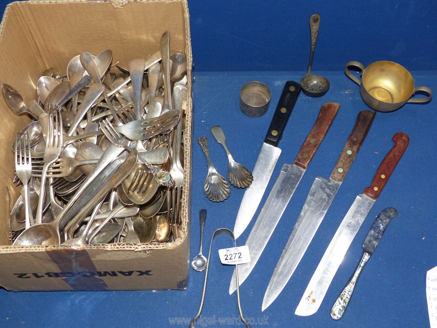 A quantity of assorted cutlery including forks, knives, spoons, carving knife, bread knife, etc.