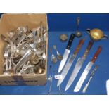 A quantity of assorted cutlery including forks, knives, spoons, carving knife, bread knife, etc.