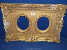 A dual aperture gilt plastered picture Frame, with losses to frame, overall frame size 22¾" x 15¾",