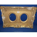 A dual aperture gilt plastered picture Frame, with losses to frame, overall frame size 22¾" x 15¾",