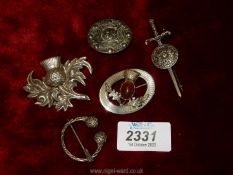 Five silver Celtic brooches; thistle, sword, etc.