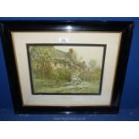 A framed and mounted Lithograph by Jacob Brooks titled Cotswold Cottage.