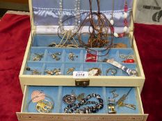 A jewellery box and contents including earrings, pairs of cufflinks, brooches, necklaces, etc.