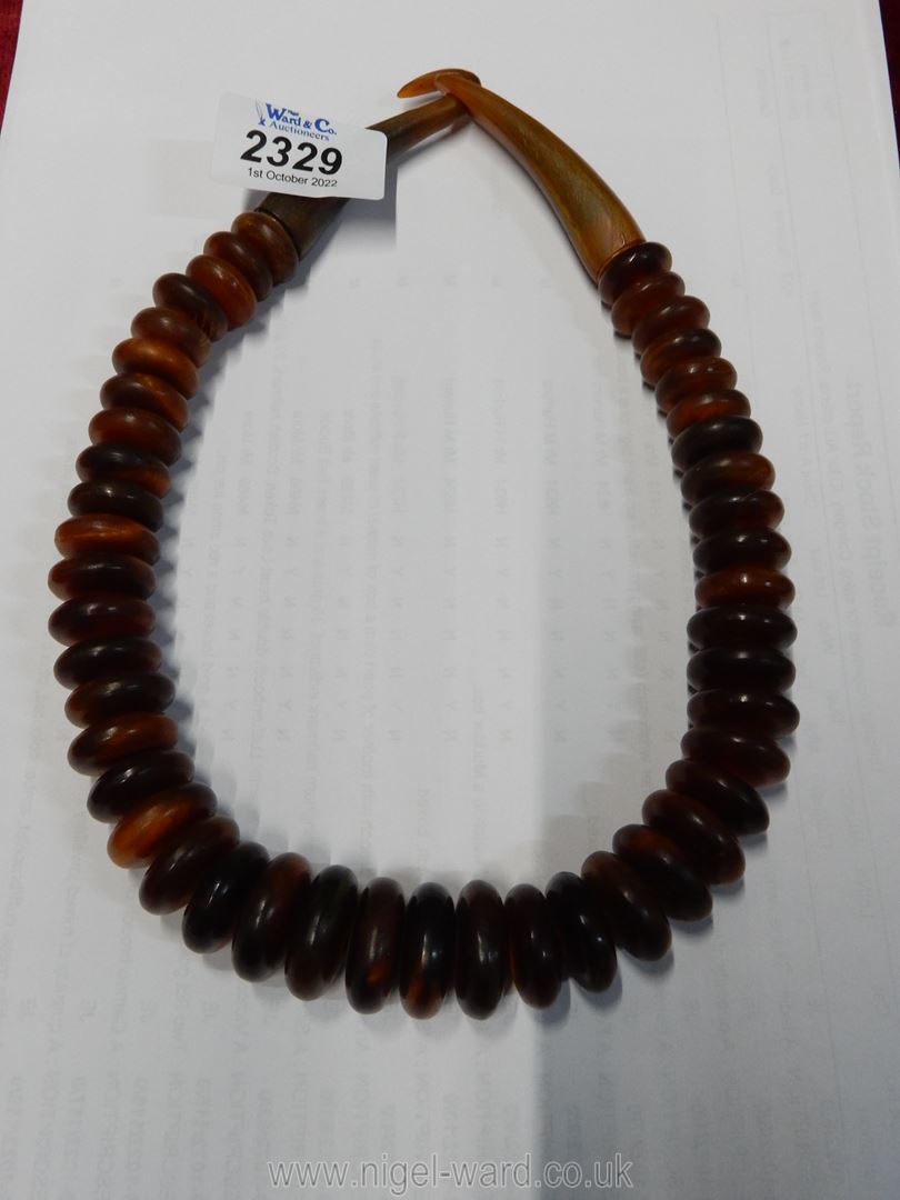 A horn necklace possibly by Catherine Noll composed of 46 amber coloured horn discs,