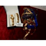 A small quantity of jewellery including beads, necklaces, loose beads, a cased watch,