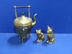 Two brass cats plus a brass kettle and burner.