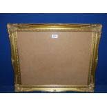 An ornate gilt picture Frame, glazed and backed, 23" x 19¼" frame with aperture of 19¼" x 15½".