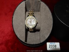 A ladies Citizen Eco watch having mother of pearl face and metal bracelet.