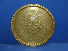 A floral decorated brass charger, 18 1/2" diameter.