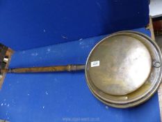 A copper warming pan with floral detail, (some damage to joint of handle).