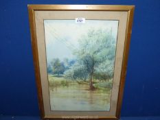 A framed and mounted watercolour of a River landscape and a church in the distance, glass a/f.