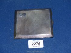 A Silver cigarette/card Case, engine turned with monogram, London 1927, maker MPG, 155 gms.