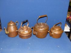 Three copper kettles, (one with finial missing) and a copper water jug with brass spout.