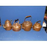 Three copper kettles, (one with finial missing) and a copper water jug with brass spout.